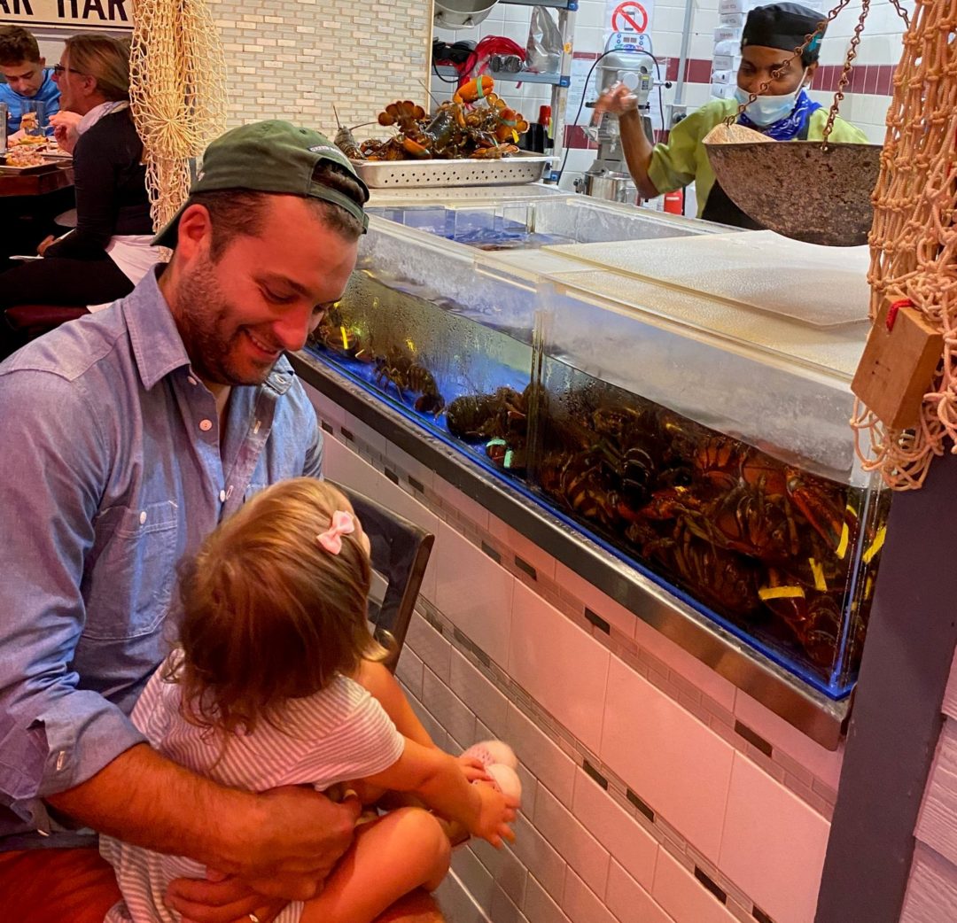 Geddy's Bar Harbor Maine, fresh Maine lobster straight from our live lobster tank, father showing daughter live lobsters.