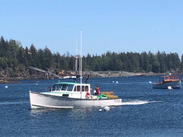 Lobster boat with lobster traps - going out to check the lobster buoys to see if they caught any lobsters today.