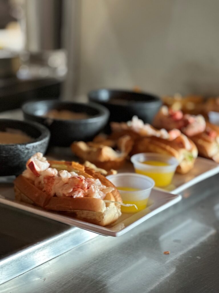 Geddy's famous mini-lobster roll bakes, offering a sample of Maine's popular dishes - lobster, clam chowder, and blueberry tart. 