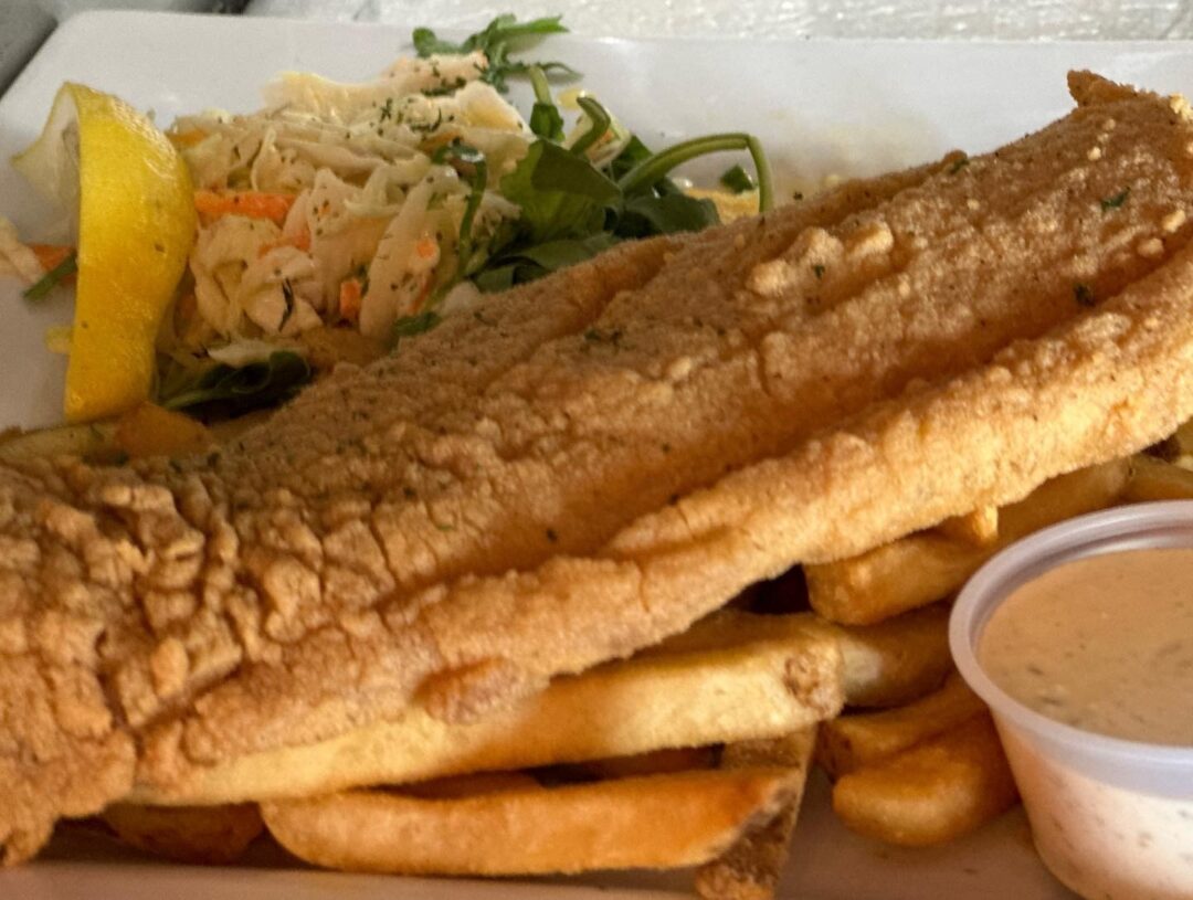 Crispy haddock fish and chips with fries, coleslaw, and house-made tartar sauce at Geddy's in Bar Harbor